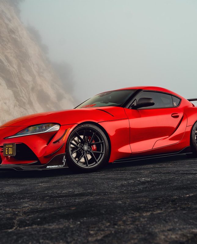 An image of a red A90 Toyota Supra with gloss black Curva Concepts CFF70 wheels
