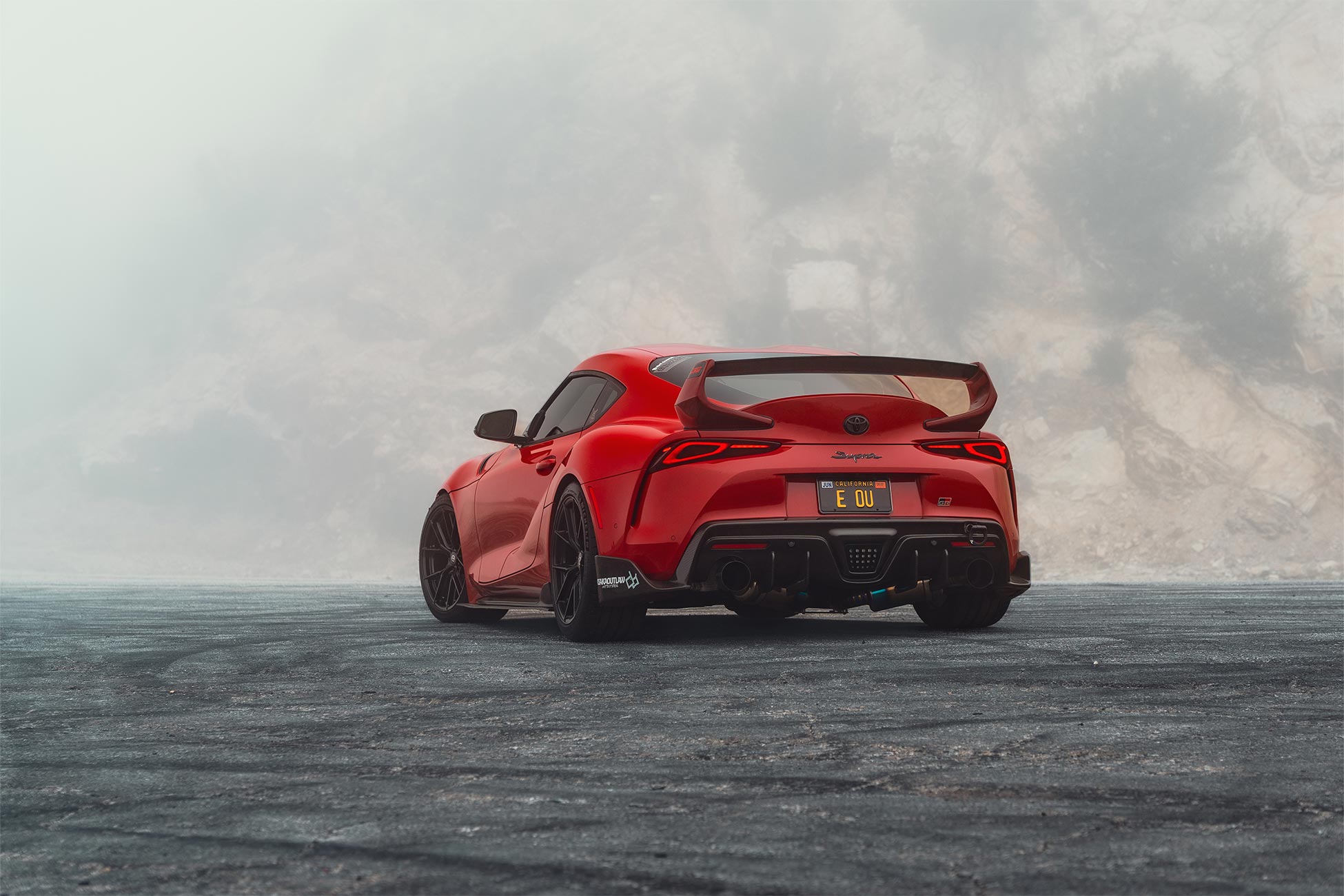 An image of a red A90 Toyota Supra with gloss black Curva Concepts CFF70 wheels