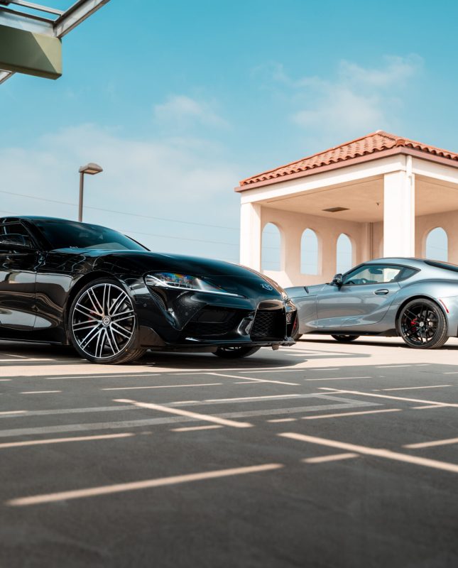 Two Toyota Supras on Curva Concepts Flow Forged Line of Wheels. The black Supra is sporting 20
