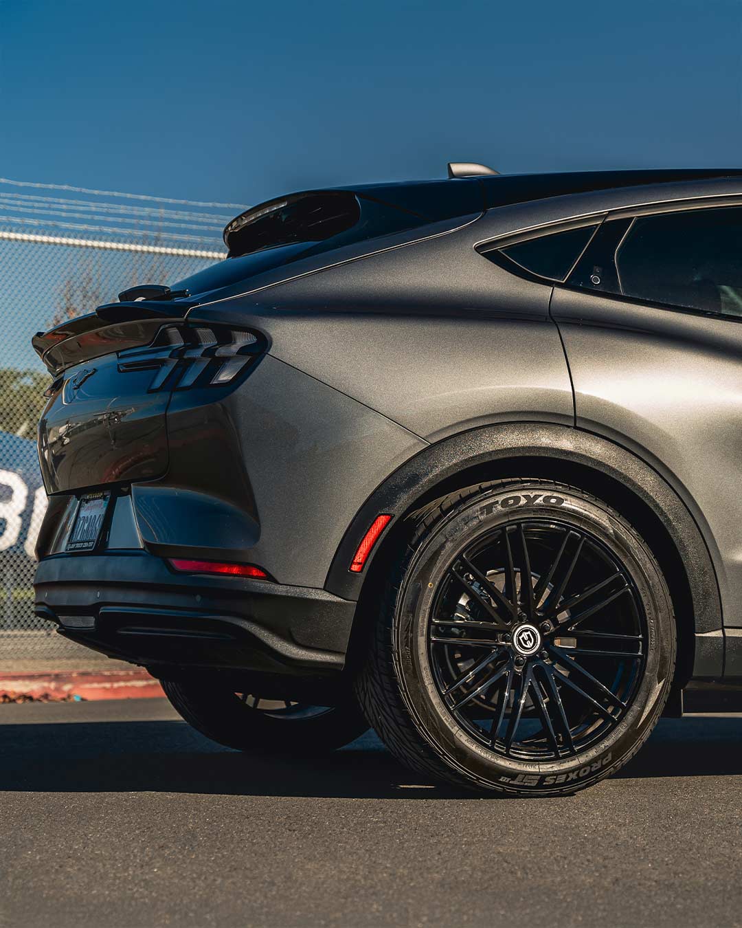 gray ford mustang mach e tight rear quarter wheel shot with gloss black curva concepts cff50 wheels