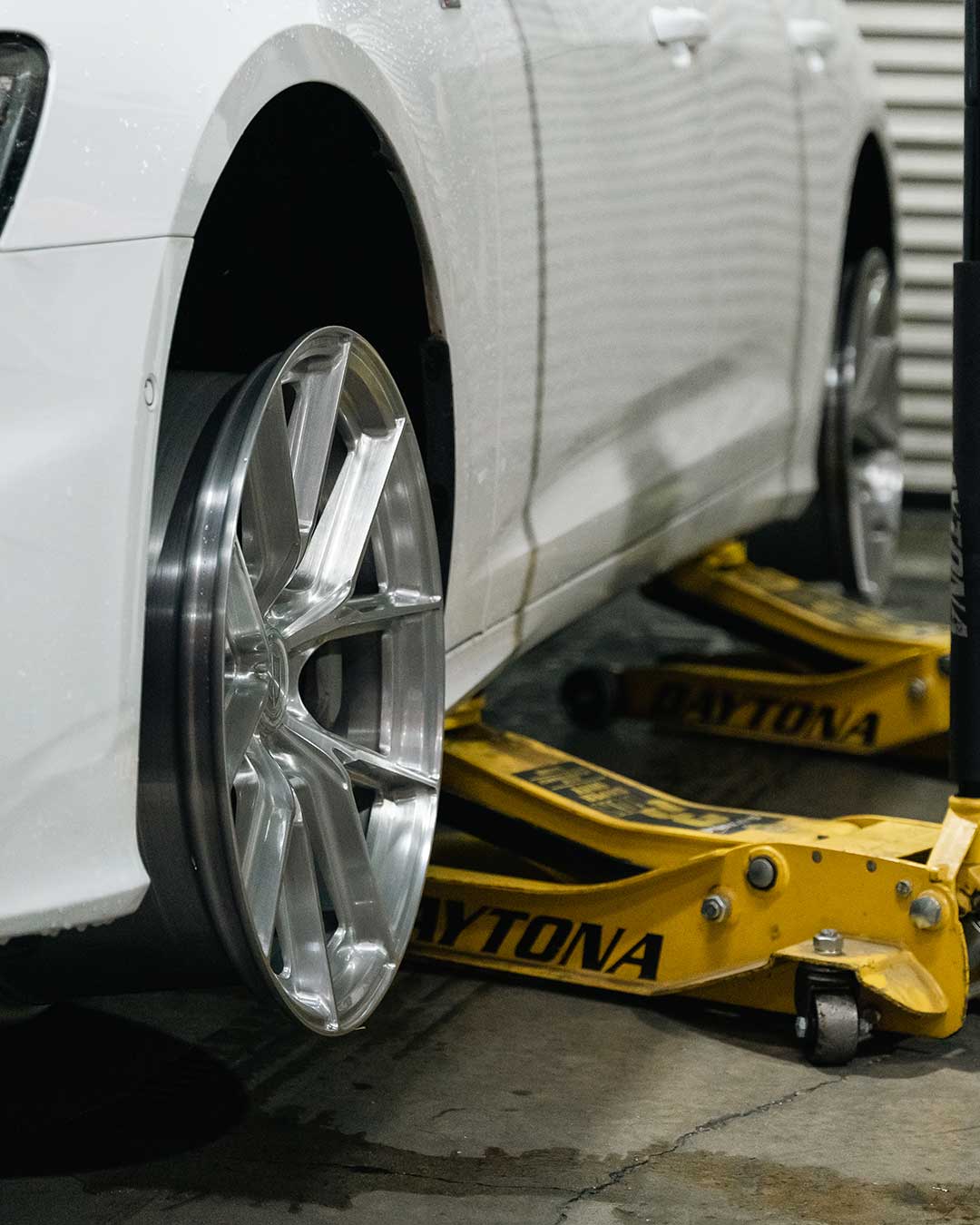 white audi a6 on jacks for test fitment with flow forged cff70 wheels