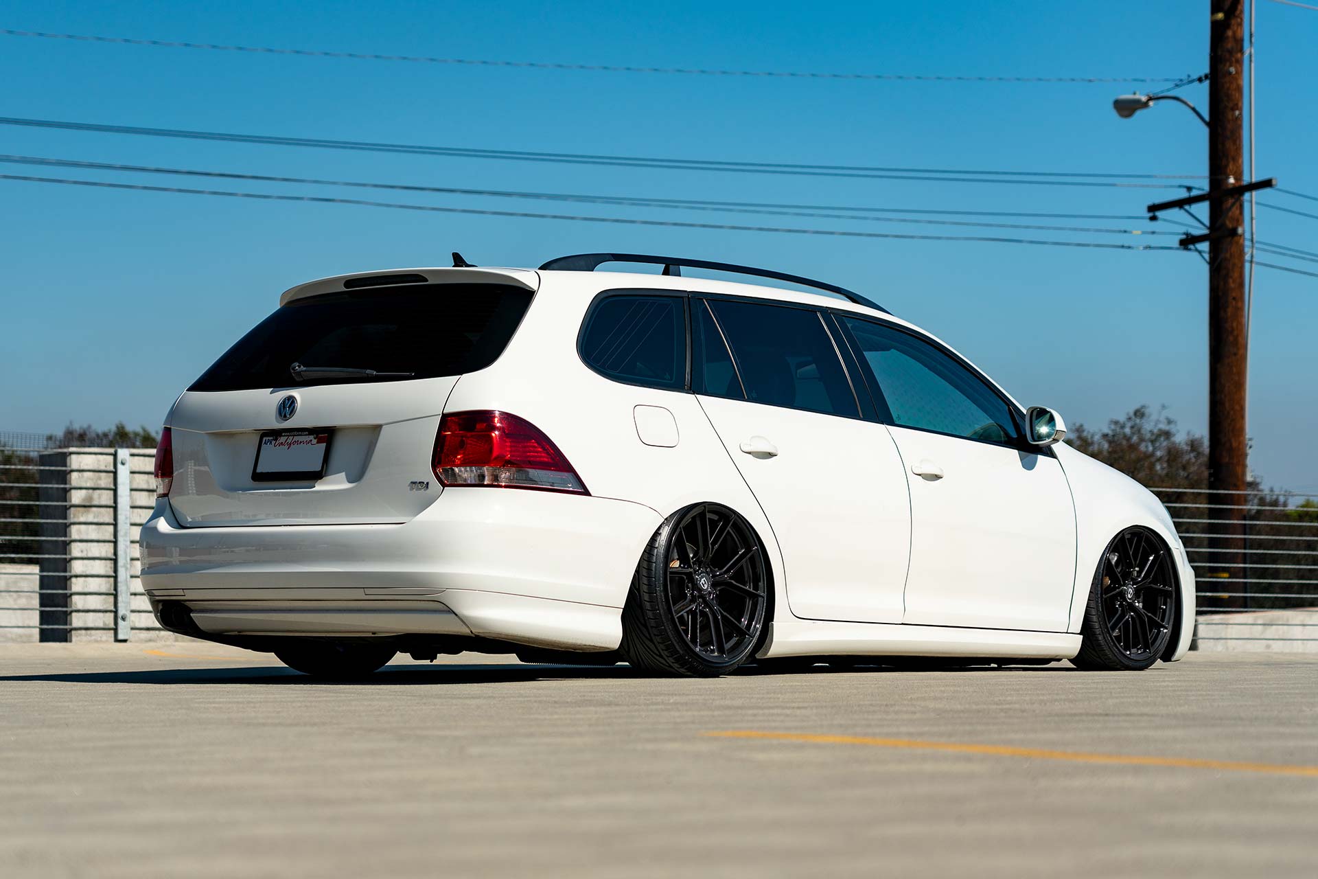 white volkswagen jetta sportwagen with gloss black cff70 flow forged wheels